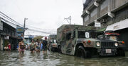 US Navy 091004-M-9443M-134 Members of the U.S. Armed Forces and the Armed Forces of the Philippines deliver family food packs
